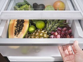 Fruit and vegetables are placed in a drawer in a fridge freezer.