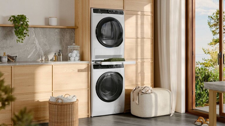 A washing machine and tumble dryer from Electrolux, stacked in a laundry room.