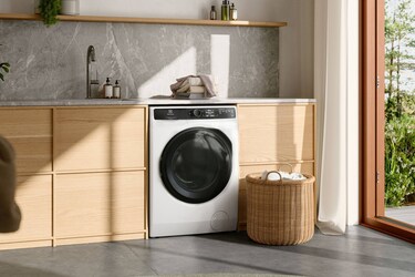 Electrolux washing machine in a bright laundry room.
